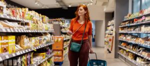 Woman shopping down a snack isle in the store.