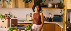 Loyal customer standing with products in her kitchen.