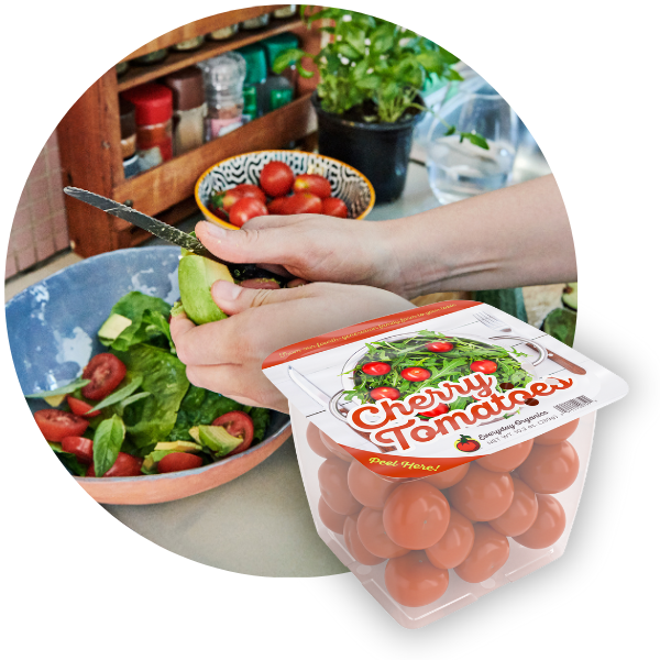 Cherry tomatoes in a tray with lidding film next to an image of someone using tomatoes for a salad.