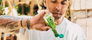 Man with a bottle of hot sauce that has a pressure sensitive label on it.