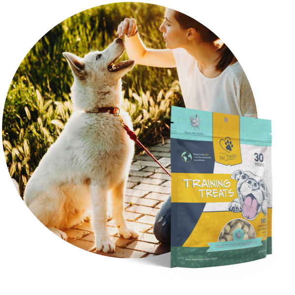 A woman giving her dog a treat.