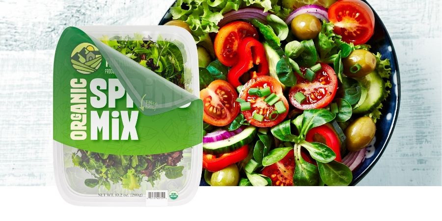 resealable lidding film packaging with organic spring mix and salad in background