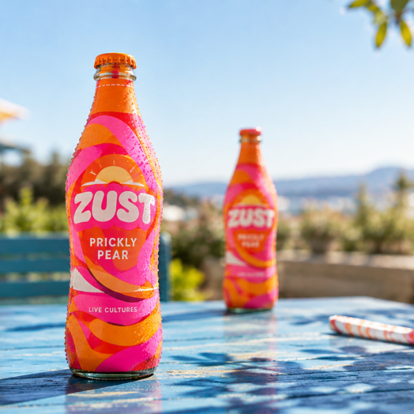 Custom shrink sleeve on juice bottle on beach